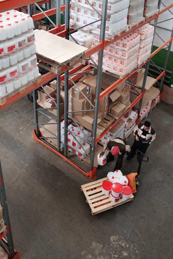Warehouse workers organizing inventory on shelves, enhancing logistics efficiency.
